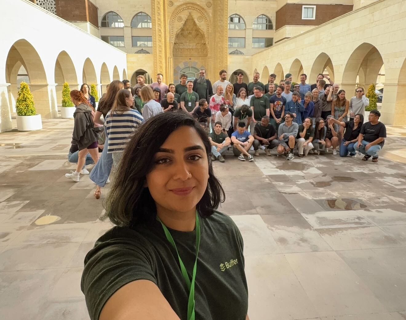 Sabreen Haziq takes a selfie in front of the Buffer team in Türkiye.