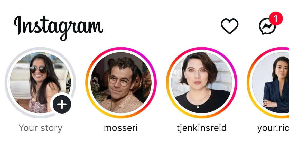 Screenshot of the Instagram app showing the Stories bar at the top. Visible are four circular profile photos with colorful rings indicating active stories
